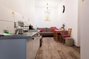 a kitchen and a living room with a couch at Hostel Królewska in Lublin
