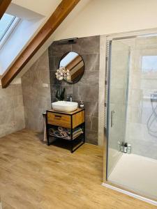 a bathroom with a sink and a shower at Apartman Detvianka 1 in Detva