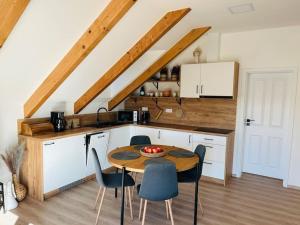 a kitchen with a table and chairs in a room at Apartman Detvianka 1 in Detva