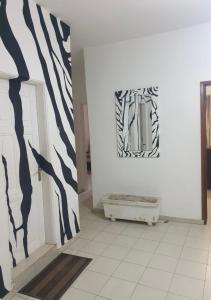 a room with black and white paintings on the wall at Le zèbre in Dakar