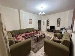 a living room with a couch and a table at Alice & Andrew Apt. Few Steps to Madaba Old City Center in Madaba