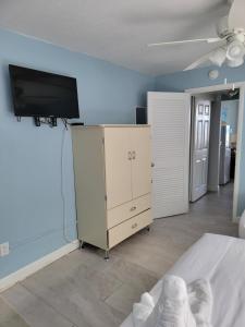 1 dormitorio con 1 cama y TV en la pared en Nassau Inn en Wildwood Crest