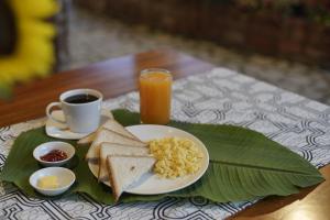 a plate of food with toast and a cup of coffee at Muyuterra in Moyobamba