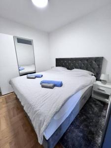 a bedroom with a bed with two towels on it at Greywood relax apartment in Zagreb
