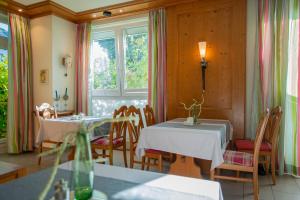 a dining room with two tables and a window at Hotel Lachnerhof in Erlangen