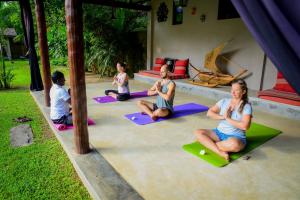 a group of people sitting in a yoga class at Villa 386 in Ahungalla