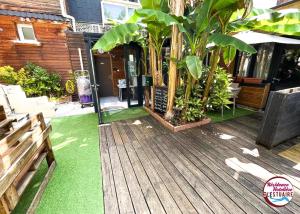 a wooden deck with green grass on a house at Résidence Hôtelière de l'Estuaire - Le Havre Centre in Le Havre