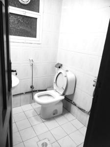 a bathroom with a toilet and a window at 05 Burjuman metro stations Unisex Hostel Private room - 05 in Dubai