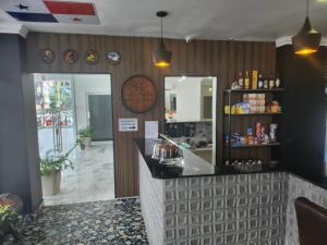 a bar in a restaurant with a mirror at Hotel Via Espana in Panama City