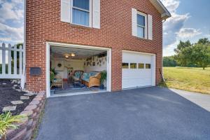 a brick house with a garage and a driveway at The MD and PA Line Retreat Scenic Country Getaway! in Emmitsburg