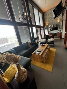 a living room with a couch and a table at Himos Aurinkopaikka 3 in Jämsä