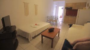 a living room with a table and a couch and a tv at Athena Kythera in Dhiakofti