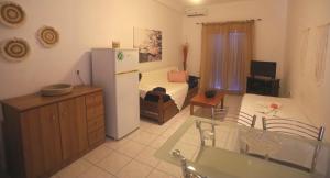 a kitchen and living room with a refrigerator and a table at Athena Kythera in Dhiakofti