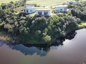 an aerial view of a house on an island in the water at House on the Hill in Heidelberg