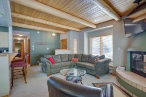 a living room with a couch and a fireplace at Amalia Mountain Getaway with Deck, Fireplace! 