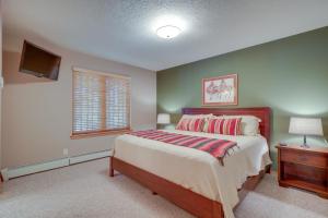 a bedroom with a large bed and a television at Amalia Mountain Getaway with Deck, Fireplace! 