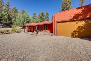 a red house with a garage and a driveway at Amalia Mountain Getaway with Deck, Fireplace! 