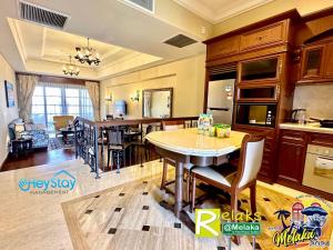 a kitchen with a table and a dining room at CasaDeRio DeluxRiverSuite Walk5minsToJonkerSt By Heystay Management in Melaka