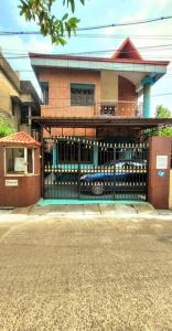 a building with a gate in front of a house at Feel the Bong vibes in a villa nearest to airport. in Kolkata