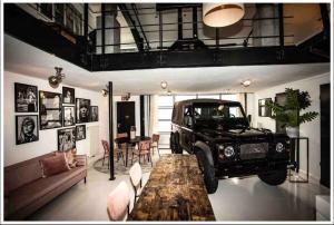 a truck parked in a living room with a table at Ivory (car) loft / Carloft in Neuwied