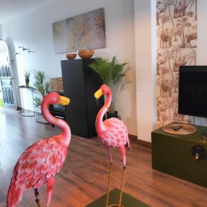 two pink flamingos are standing in a room at MAREZIA in Corralejo