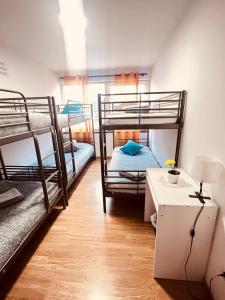 a room with two bunk beds and a table at HOSTEL GOLDEN STAR in Gião