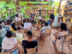 a group of people sitting in chairs in a store at Hostal El Marquez Pavas in La Cumbre