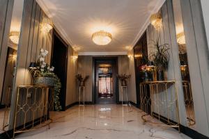 a hallway of a building with marble floors and chandeliers at Hotel Lacu Rosu in Lacu Rosu