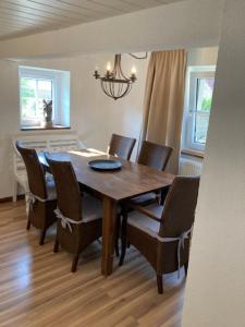 a dining room with a wooden table and chairs at Haus Buckaroo – Rancho el Rosal in Bad Mergentheim