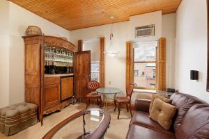 a living room with a couch and a bar at Independence Square Unit 306 in Aspen