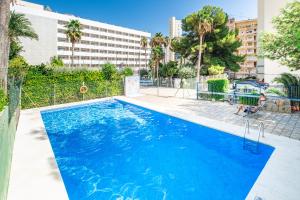 a swimming pool with blue water in a building at Donna II 8-38 Apartment Levante Beach in Benidorm