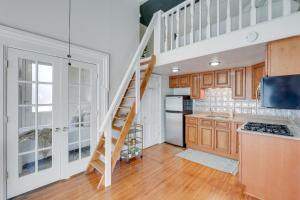 a kitchen with stairs leading up to a loft at Historic New Albany Apartment about 6 Mi to Louisville in New Albany