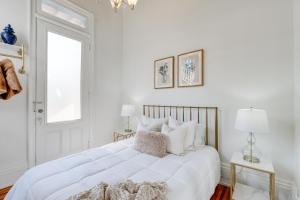 a white bedroom with a large bed and a window at Historic New Albany Apartment about 6 Mi to Louisville in New Albany