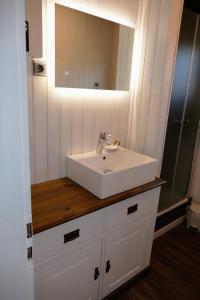 a bathroom with a white sink and a mirror at Ferienhaus Bergblick in Meschede