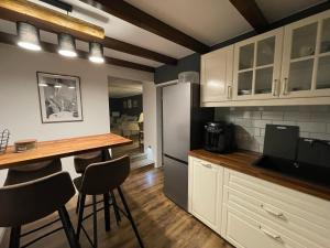 a kitchen with white cabinets and a table and chairs at In Abrahams Schoß in Blankenfelde