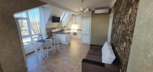 a kitchen and dining room with a table and chairs at Airport apartament in Sîngera