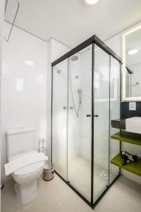 bagno con doccia in vetro e servizi igienici di Belíssimo e moderno studio para casais STU309 a Florianópolis