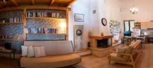 a living room with a couch and a fireplace at Villa Achinos in Akhinós