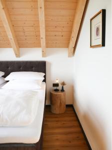a bedroom with a bed and a wooden ceiling at Ahütten in Bodenmais