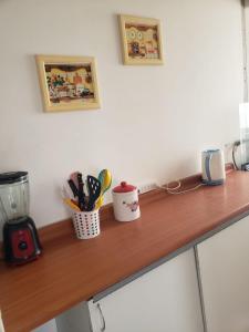 a wooden counter top with utensils in a kitchen at Dichato full vista al mar in Tomé