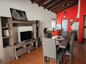 a living room with a dining table and a television at Complejo Cerrado Zona Shopping in Guaymallen