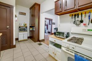 a kitchen with white cabinets and a stove top oven at Pet-Friendly Pittsburgh Home about 9 Mi to Downtown! in Pittsburgh