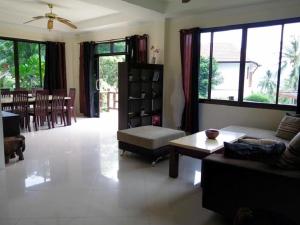 a living room with a couch and a table at Viking House Villa Deluxe in Ko Tao