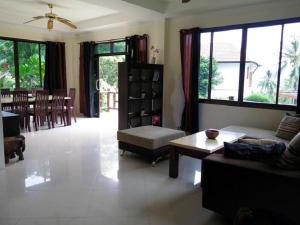 a living room with a couch and a table at Viking House Villa Deluxe in Koh Tao