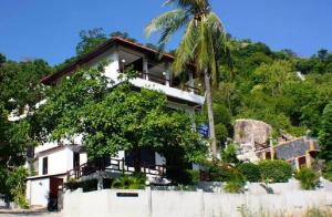 a house on a hill with a palm tree at Viking House Villa Deluxe in Koh Tao