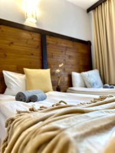 a hotel room with two beds with towels on them at Red House Family house in Bansko