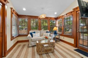 a living room with a couch and a tv at Flagler Cottage - 1 Block to Historic District in St. Augustine