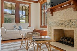 a living room with a couch and a fireplace at Flagler Cottage - 1 Block to Historic District in St. Augustine