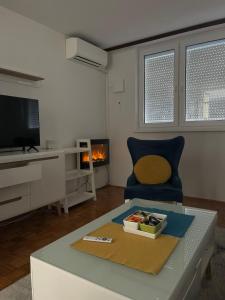 a living room with a couch and a table at Apartman Zenica in Zenica