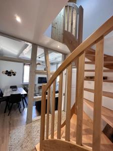 a wooden staircase in a house with a dining room at Le trésor de Khalis in Colmar